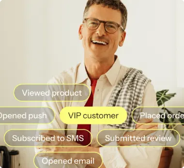 A photograph of a smiling man features a graphic overlay highlighting profile attributes like "VIP customer" and "Subscribed to SMS."