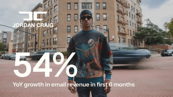 Person in a patterned sweater stands on a city street. Text: "Jordan Craig 54% YoY growth in email revenue in first 6 months.