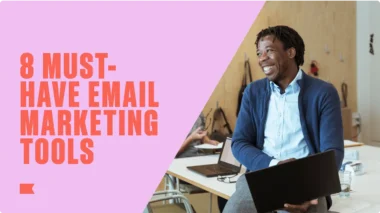 Text "8 Must-Have Email Marketing Tools" beside a smiling person holding a laptop in an office setting.