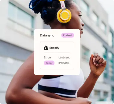 Data sync between Klaviyo and Shopify showing 1 error, a last sync of 3/12/2025, with a woman going for a run in the background image